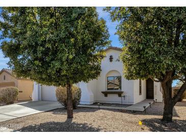 Charming single-story home with stucco exterior and mature trees in a well-maintained front yard at 18502 N Celis St, Maricopa, AZ 85138