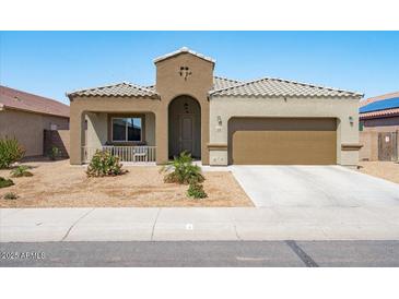 Charming single-story home with a two-car garage and well-maintained xeriscaped front yard at 23830 W Romley W Ave, Buckeye, AZ 85326