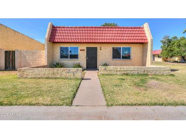 Charming single-story home with a red tile roof and well-maintained front yard at 3324 W Tangerine Ln, Phoenix, AZ 85051