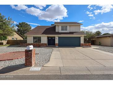 Charming two-story home featuring a blue garage door and mailbox in a beautiful neighborhood at 4523 W Bluefield Ave, Glendale, AZ 85308