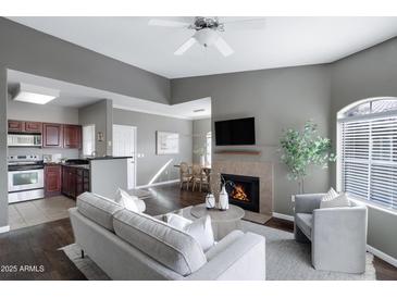 Inviting living room with fireplace, sleek furniture, and hardwood floors provides a comfortable living space at 5335 E Shea Blvd # 2022, Scottsdale, AZ 85254