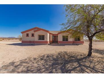 Charming single-story home featuring a desert landscape, tile roof and inviting entryway at 6431 N 418Th Ave, Tonopah, AZ 85354