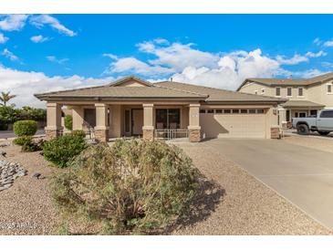 Charming single-story home with a well-manicured front yard and a two-car garage in a quiet neighborhood at 700 W Gascon Rd, San Tan Valley, AZ 85143