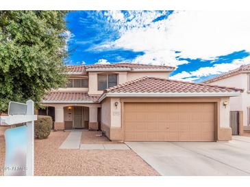 Inviting two-story home featuring a well-maintained front yard and an attached two-car garage at 11023 E Florian Ave, Mesa, AZ 85208