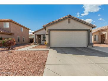 Charming home featuring a well-maintained front yard and a convenient two-car garage at 11813 W Sierra St, El Mirage, AZ 85335