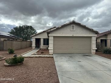 Charming single-story home featuring a two-car garage and low-maintenance landscaping in a quiet neighborhood at 15023 W Caribbean Ln, Surprise, AZ 85379