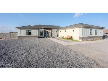 Charming single-story home with gray gravel landscaping and a welcoming blue front door at 2040 W Gail Rd, Queen Creek, AZ 85142