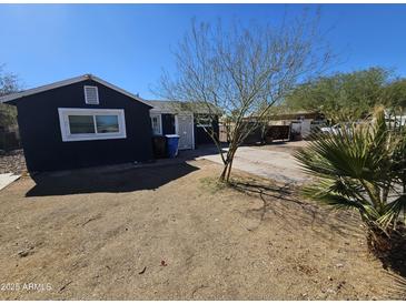 Charming single-story home featuring a xeriscaped front yard with desert-friendly landscaping at 2205 W Hadley St, Phoenix, AZ 85009