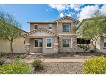 Attractive two-story home with stone and siding accents, well-manicured landscaping, and sunny curb appeal at 29243 N 122Nd Ln, Peoria, AZ 85383