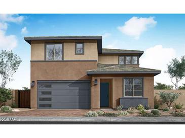 Contemporary two-story home featuring a neutral color scheme, an attached garage, and manicured desert landscaping at 40234 N Alegre Dr, San Tan Valley, AZ 85140