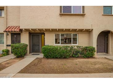 Charming townhouse with a well-maintained lawn and inviting front entrance at 6841 E Osborn Rd # C, Scottsdale, AZ 85251