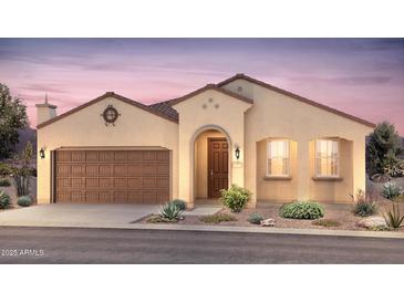 Charming single-story home with a two-car garage, stucco siding, and a beautifully landscaped front yard at 7681 W Meadowlark Way, Florence, AZ 85132