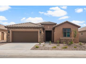 Charming single-story home featuring a well-manicured landscape, neutral stucco, and a cozy entrance at 7723 W Cactus Wren Way, Florence, AZ 85132