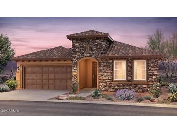 Beautiful single story home with a stone facade, tile roof, landscaped yard, and a two car garage at 7851 W Meadowlark Way, Florence, AZ 85132