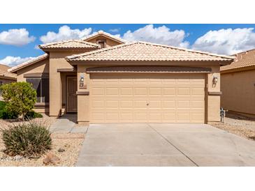 Charming single-story home featuring a well-maintained front yard, a two-car garage, and beautiful tile roof at 1100 E Vernoa St, San Tan Valley, AZ 85140