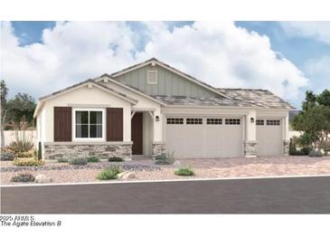 Charming single-story home with a three-car garage, stone accents, neutral colors, and simple landscaping at 12377 W Marguerite Ave, Avondale, AZ 85323