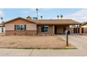 Charming single-story home with a covered porch and a low-maintenance front yard at 12402 N 36Th Dr, Phoenix, AZ 85029