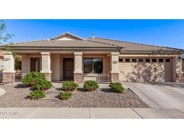 Charming single-story home with a well-maintained front yard and a two car garage at 17574 W Corrine Dr, Surprise, AZ 85388