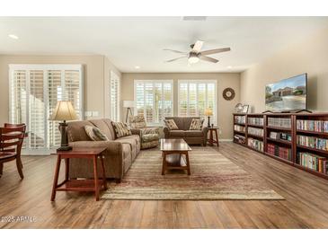 Spacious living room featuring wood floors, neutral walls, and plenty of natural light at 21362 N 260Th Ln, Buckeye, AZ 85396