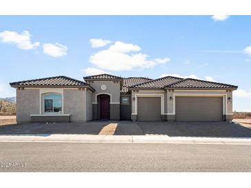 Charming single-story home with a three-car garage and a meticulously tiled roof at 26657 W Renee Dr, Buckeye, AZ 85396