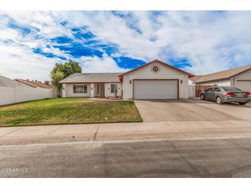 Charming single-story home with a two-car garage and well-manicured front yard at 2327 W Rockwell Ct, Chandler, AZ 85224