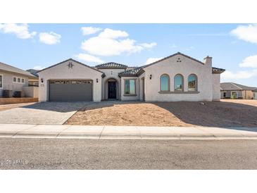 Stunning single-story home featuring a three-car garage, elegant arches, and neutral color palette at 26535 W Mcrae Dr, Buckeye, AZ 85396