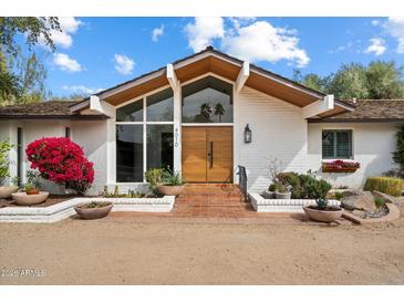 Inviting front entrance with modern double doors, ample natural light, and desert landscaping at 4010 E Montebello Ave, Phoenix, AZ 85018
