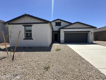 Charming single-Gathering home featuring a two-car garage and a low maintenance desert landscape at 47251 W Mellen Ln, Maricopa, AZ 85139
