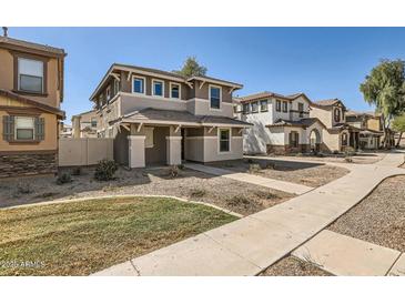 Inviting two-story home with neutral tones and desert landscaping for a low-maintenance yard at 5828 E Hampton Ave, Mesa, AZ 85206