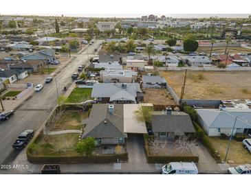 This aerial view shows a charming neighborhood with mature landscaping and well-maintained homes at 660 E 1St Ave, Mesa, AZ 85204