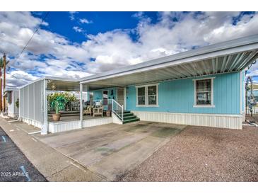A charming single-story home showcasing a covered carport and pleasant exterior paint at 7807 E Main St # H12, Mesa, AZ 85207