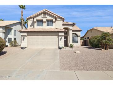Charming two-story home with a tile roof, desert landscaping and a spacious two car garage at 9264 E Hillery Way, Scottsdale, AZ 85260