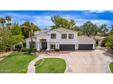 Expansive two-story home featuring a three car garage and professionally landscaped front yard at 1152 W Sunrise Pl, Chandler, AZ 85248