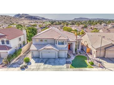 Stunning two-story home showcasing a manicured lawn and three-car garage nestled in a picturesque neighborhood at 13236 N 13Th St, Phoenix, AZ 85022