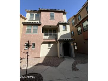 Charming two-story townhouse featuring a balcony and well-maintained landscaping at 2107 N 77Th Dr, Phoenix, AZ 85035