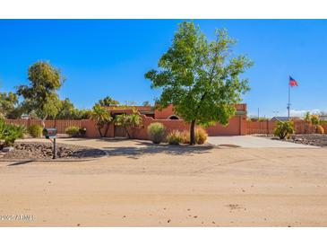 Charming single-story home featuring desert landscaping, fenced yard, and a warm, inviting exterior at 22005 N 86Th Ave, Peoria, AZ 85383