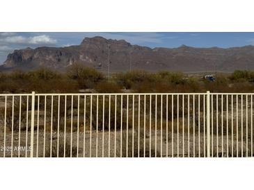 Expansive desert and mountain views from a property with a white fence in the foreground at 3301 S Goldfield Rd # 4025, Apache Junction, AZ 85119