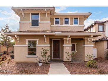 Charming two-story home showcasing neutral tones, a welcoming entryway, and manicured landscaping at 3819 E Jasper Dr, Gilbert, AZ 85296