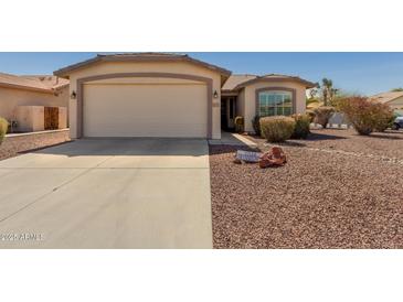 Charming single-story home featuring a two-car garage and low maintenance desert landscaping at 3921 E Runaway Bay Pl, Chandler, AZ 85249