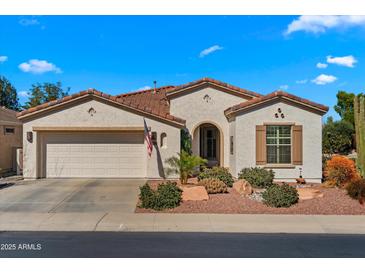 Charming single-story home featuring a neutral color, tile roof, and a well-maintained landscaped front yard at 4138 E Indigo St, Gilbert, AZ 85298