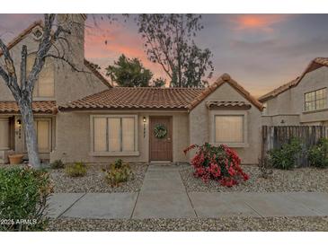 Charming single-story home with a tile roof, desert landscaping, and a welcoming front door at 4901 E Kelton Ln # 1227, Scottsdale, AZ 85254