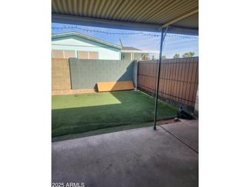 Cozy covered patio with artificial grass at 934 S Evangeline Ave, Mesa, AZ 85208