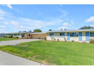 Charming single-story home with well-manicured lawn and welcoming curb appeal at 10226 W Snead S Cir, Sun City, AZ 85351