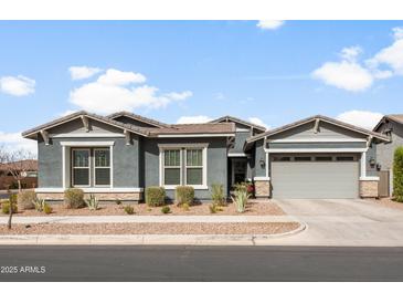 Charming single-story home featuring a two-car garage, desert landscaping, and a neutral color palette at 10322 E Topaz Ave, Mesa, AZ 85212