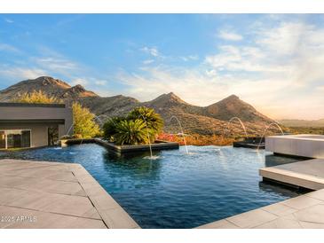 Stunning infinity pool with mountain views and water features, perfect for relaxing and entertaining at 10324 E Calle De Las Brisas --, Scottsdale, AZ 85255