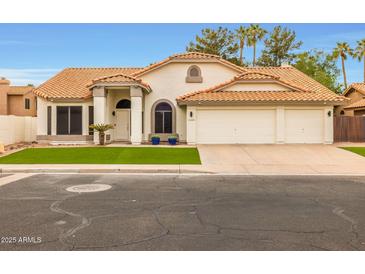 Inviting single-story home with a well-maintained lawn and a classic tile roof at 1114 S Presidio Ave, Gilbert, AZ 85233