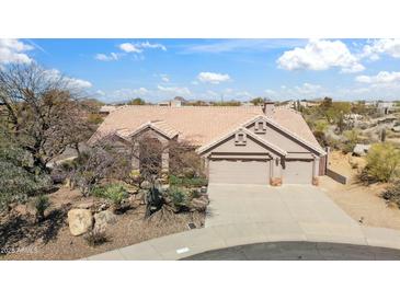 Charming home with desert landscaping, three car garage, and a beautiful tile roof at 11152 E White Feather Ln, Scottsdale, AZ 85262