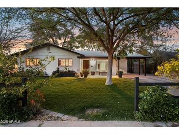 Charming home with mature trees, lush lawn, and inviting curb appeal at 1414 E Vermont Ave, Phoenix, AZ 85014