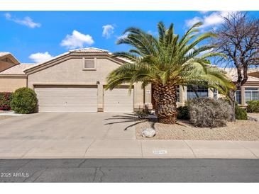 Charming single-story home featuring a well-maintained front yard with desert landscaping and a two-car garage at 16102 E Glenview Dr, Fountain Hills, AZ 85268