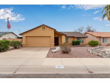 Charming single-story home featuring a neutral-colored exterior, attached garage, and well-maintained landscaping at 1647 E Christina St, Casa Grande, AZ 85122